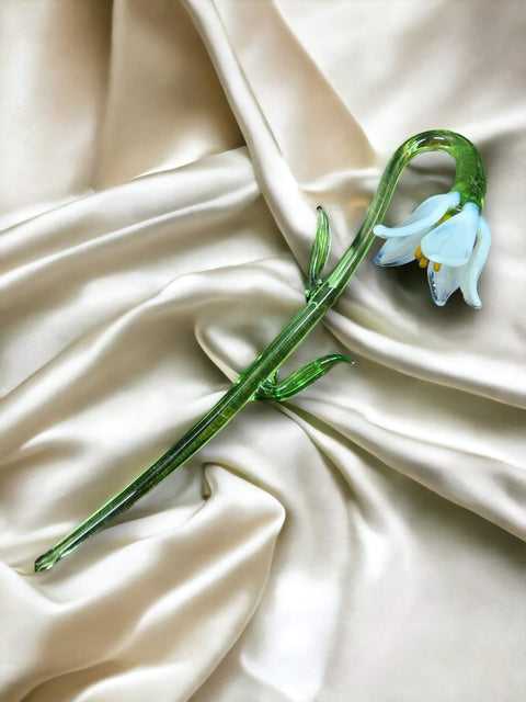 a flower that is laying on a white cloth