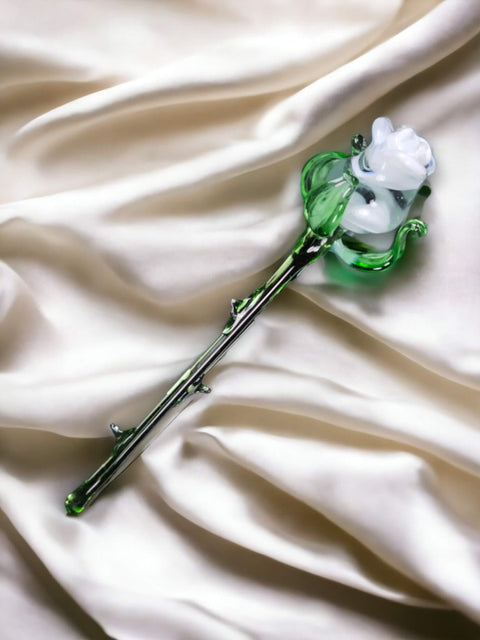 a green and white flower on a white satin