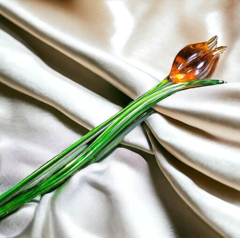 a close up of a flower on a white cloth