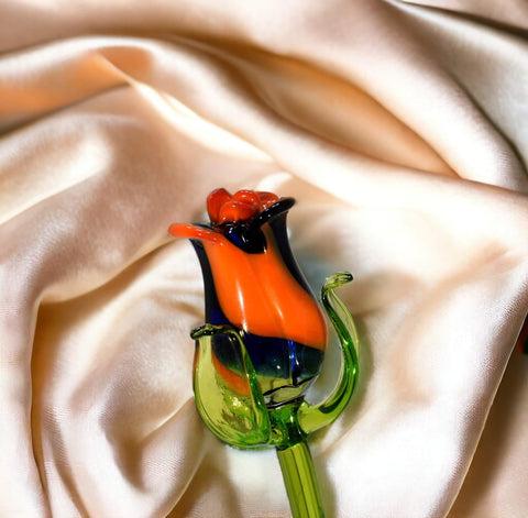 a colorful glass flower on a white cloth