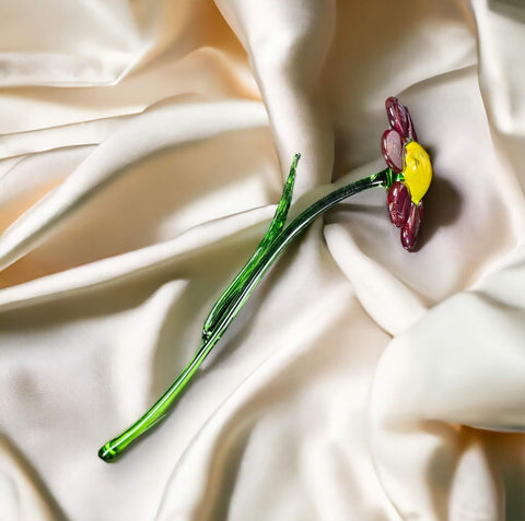 a single flower is laying on a white cloth