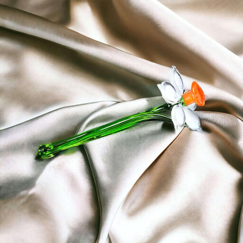 a single flower on a satin fabric