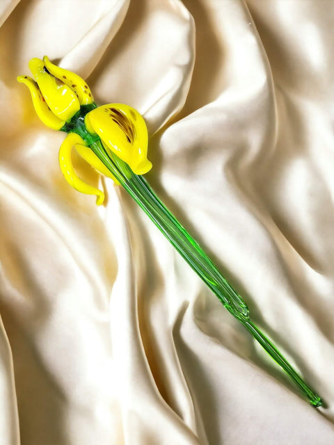 a yellow flower on a white satin background