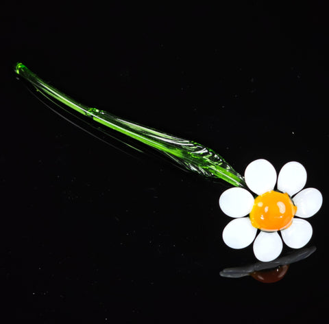 a green glass pipe with a flower on it