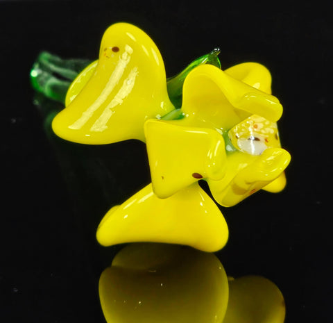 a yellow glass object sitting on top of a table