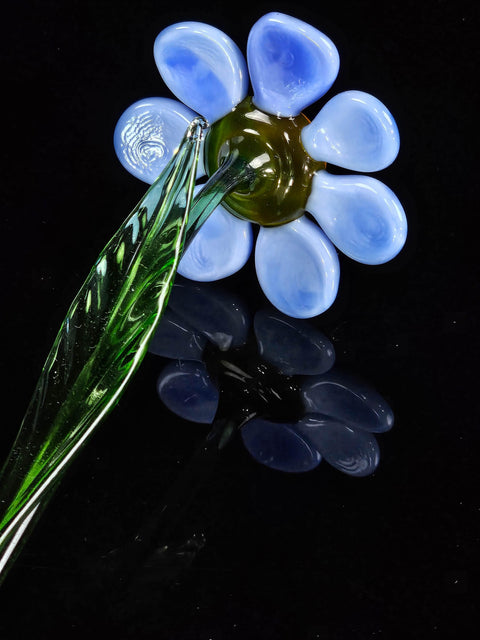 a flower shaped glass object sitting on top of a table