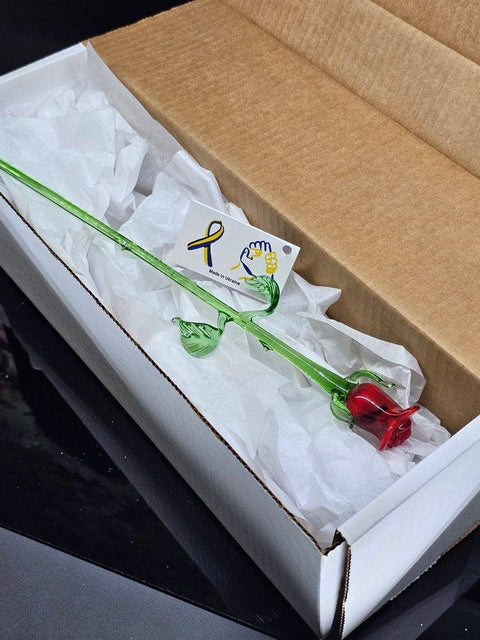 a white box with a red rose inside of it