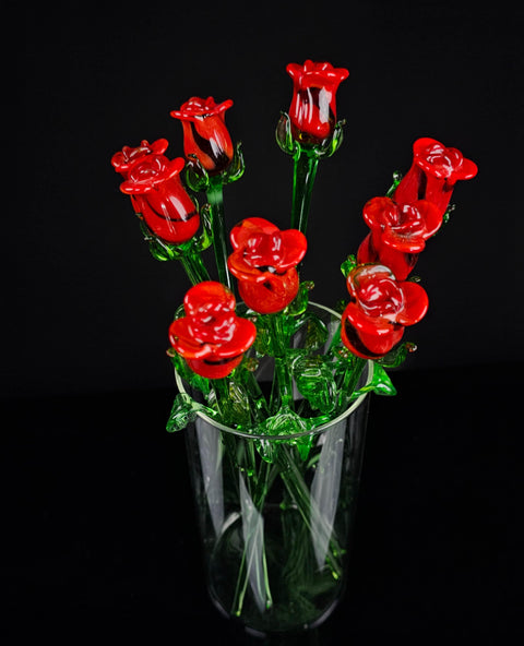 a vase filled with red flowers on top of a table