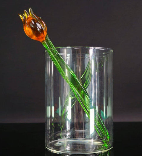 a glass vase with a flower in it