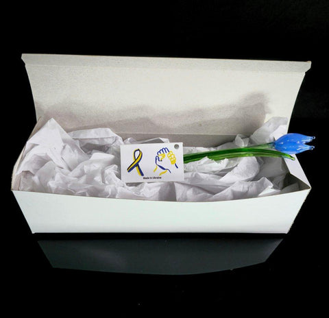 a white box with a blue flower and a yellow ribbon