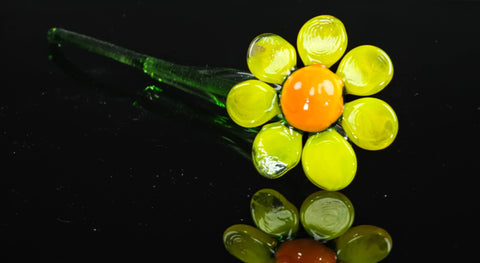 a close up of a flower shaped object on a black surface