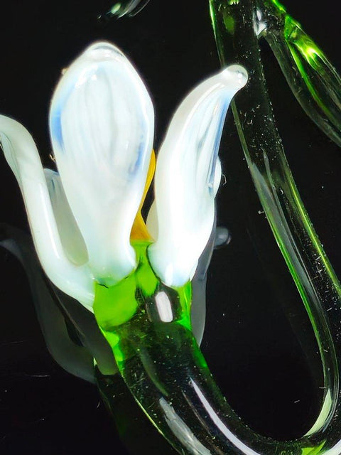 a close up of a glass flower on a black background