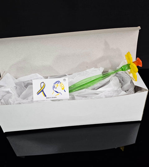 a white box with a green and yellow toothbrush in it